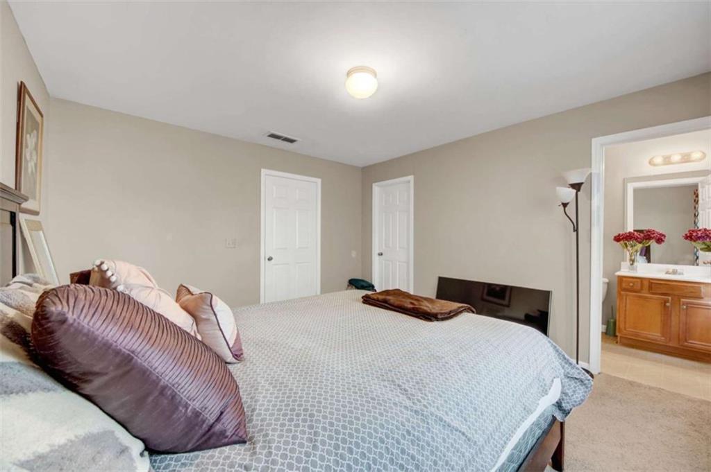 2555 Flat Shoals Road South Fulton, GA 30349 - Photo 15 of 20 a bedroom with a bed and a dresser