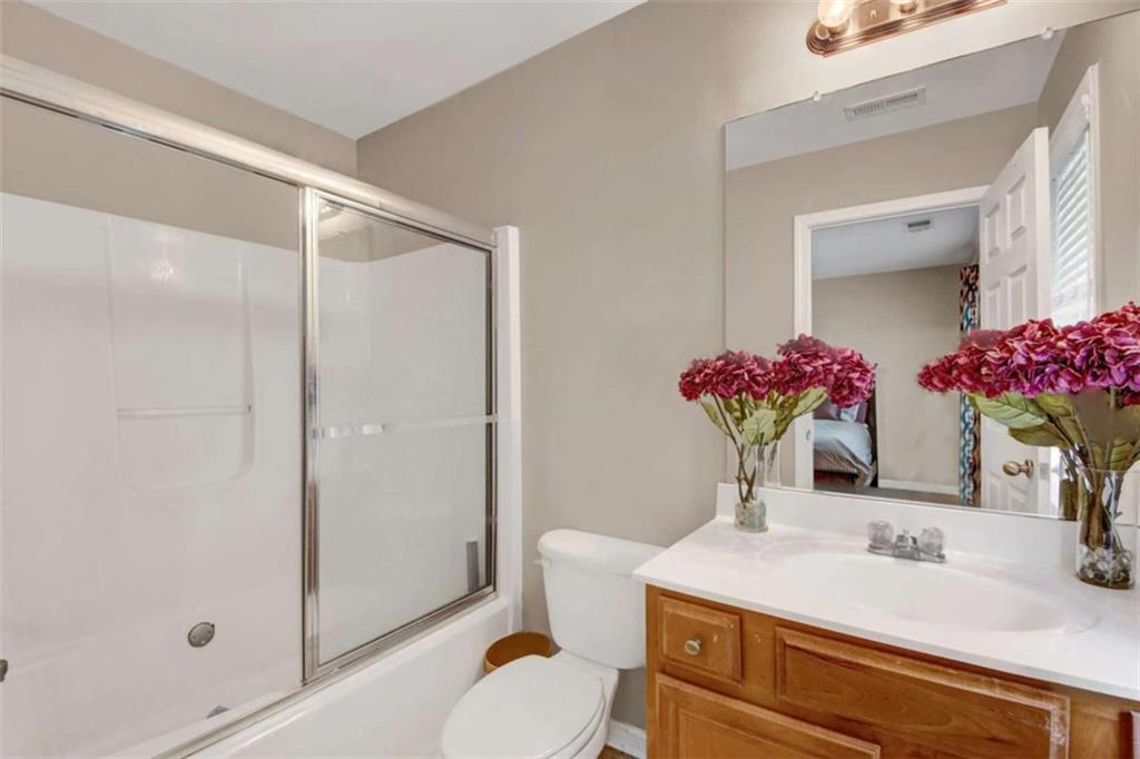 2555 Flat Shoals Road South Fulton, GA 30349 - Photo 16 of 20 a bathroom with a sink vanity mirror and toilet