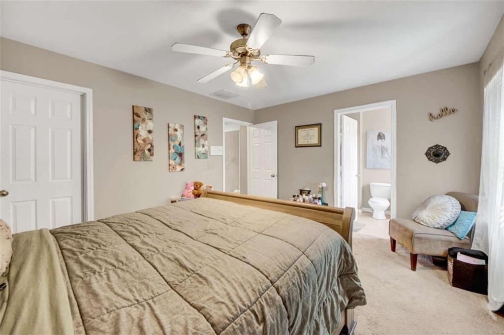 2555 Flat Shoals Road South Fulton, GA 30349 - Photo 18 of 20 a bedroom with a bed and ceiling fan
