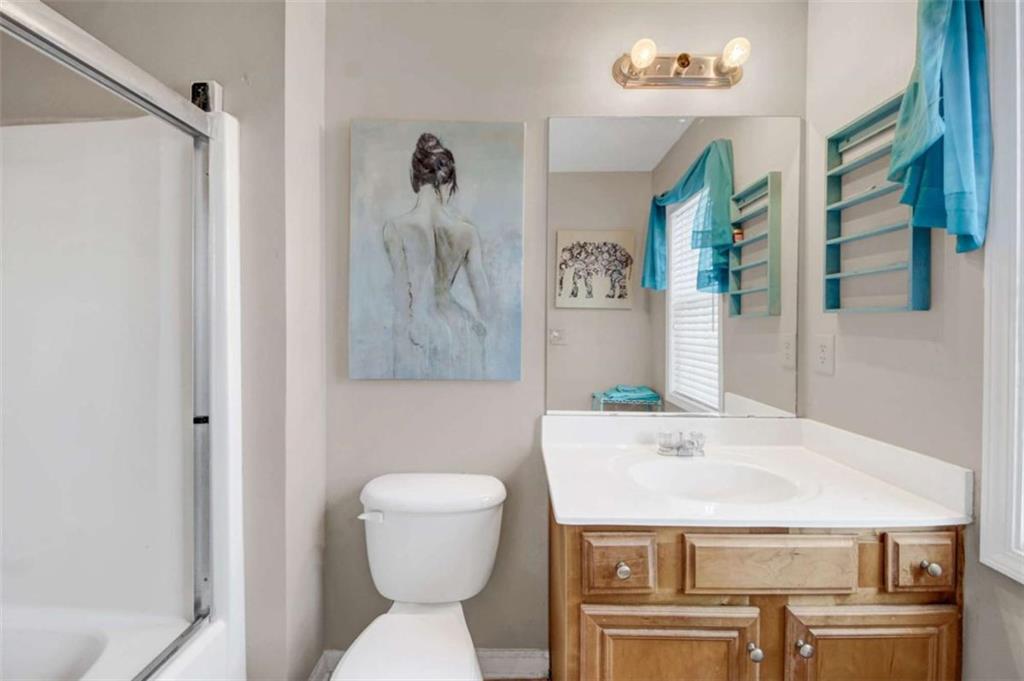 2555 Flat Shoals Road South Fulton, GA 30349 - Photo 19 of 20 a bathroom with a sink a toilet and a mirror