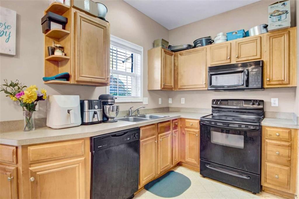 2555 Flat Shoals Road South Fulton, GA 30349 - Photo 9 of 20 a kitchen with a sink stove and microwave