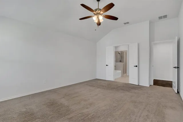 an empty room with wooden floor and window