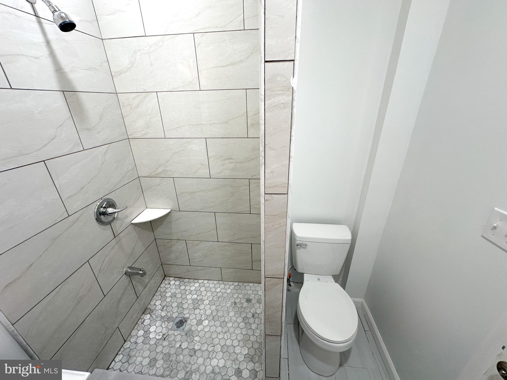 2317 North 15th Street, Unit 3 Philadelphia, PA 19132 - Photo 12 of 12 a bathroom with a toilet and a shower