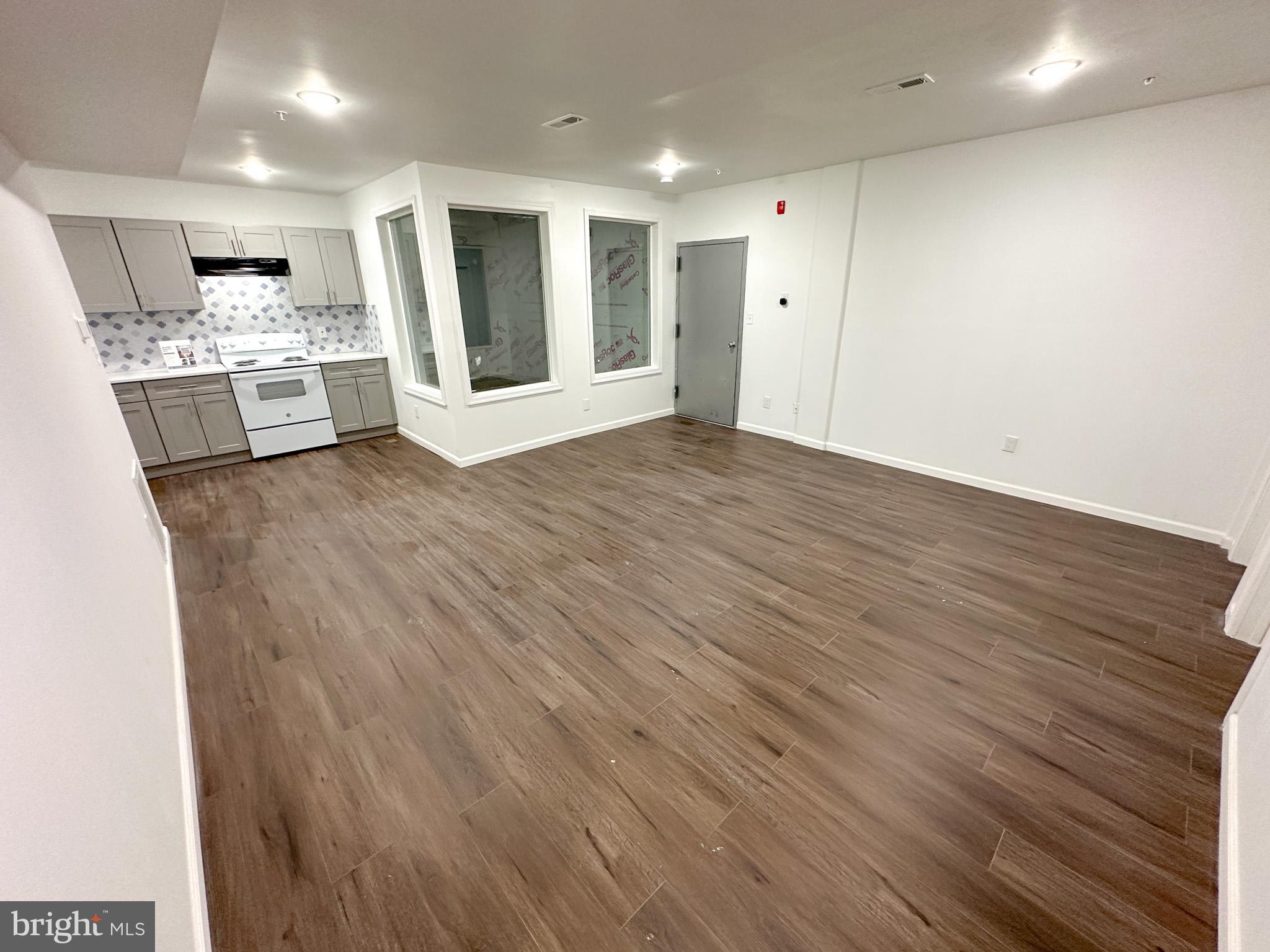 2317 North 15th Street, Unit 3 Philadelphia, PA 19132 - Photo 2 of 12 a view of a kitchen with wooden floor and a sink