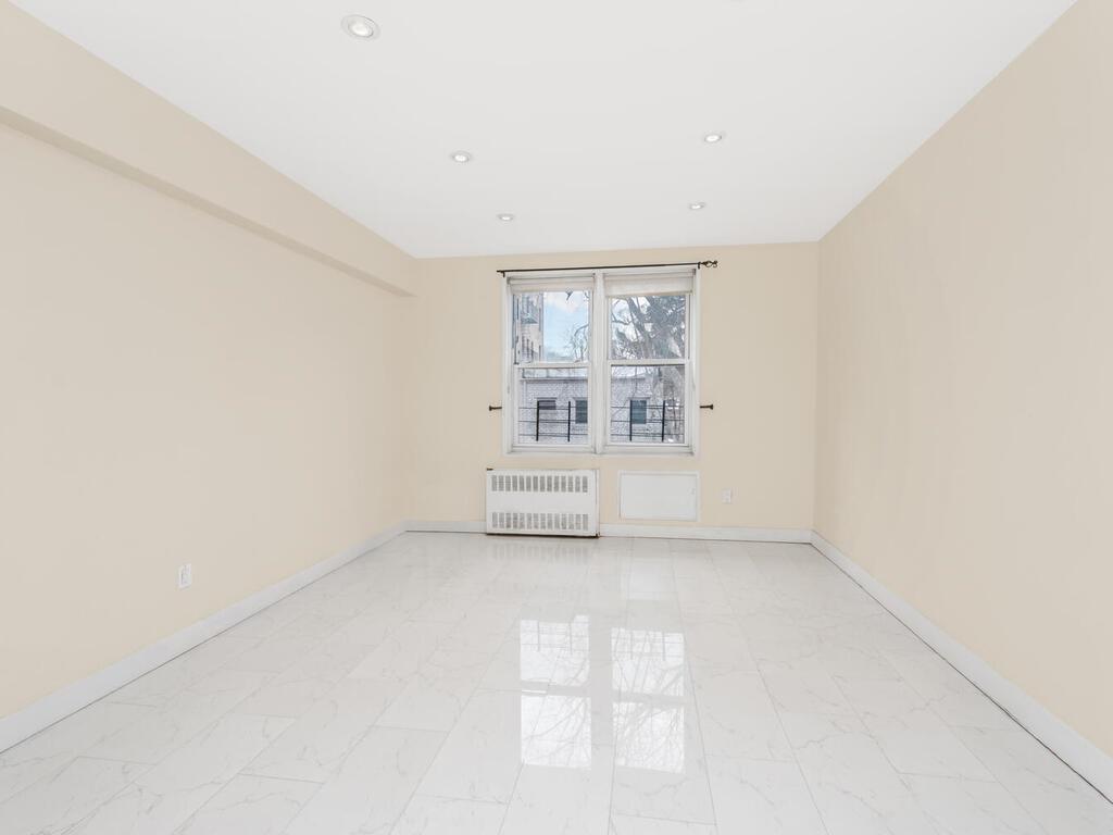 6535 Broadway, Unit 2E Bronx, NY 10471 - Photo 7 of 14 Unfurnished room with radiator, marble finish floor, baseboards, and recessed lighting