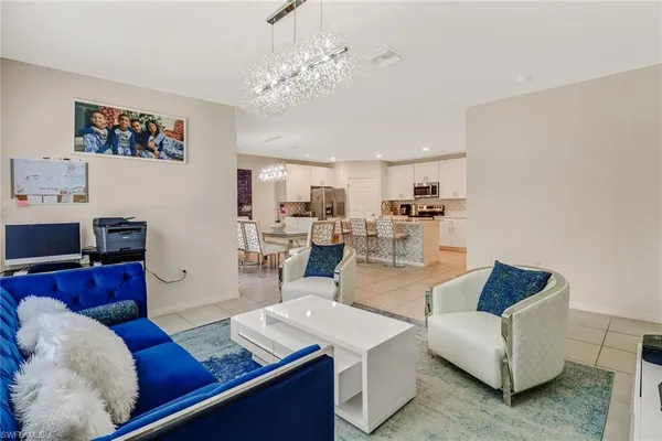 a living room with furniture and kitchen view
