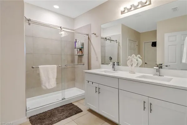 a bathroom with a shower sink and mirror