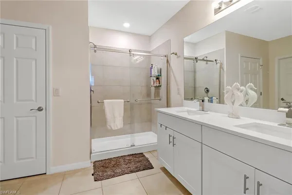 a bathroom with a shower sink and mirror