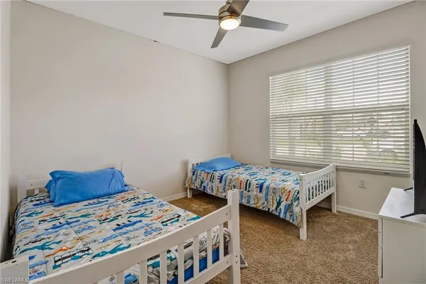 a bedroom with two beds and a window