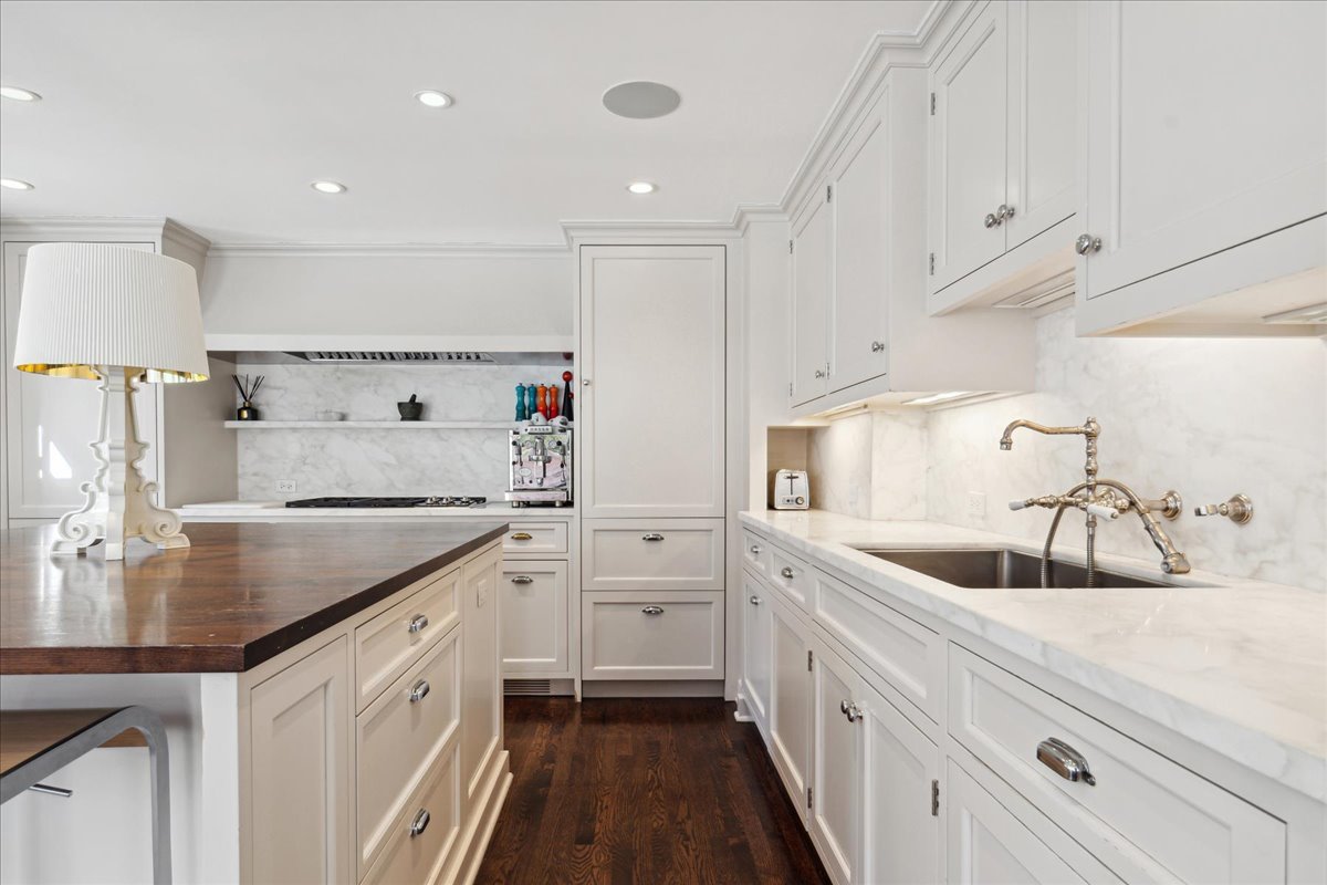 1320 Elm Tree Road Lake Forest, IL 60045 - Photo 21 of 52 a kitchen with white cabinets a sink and dishwasher