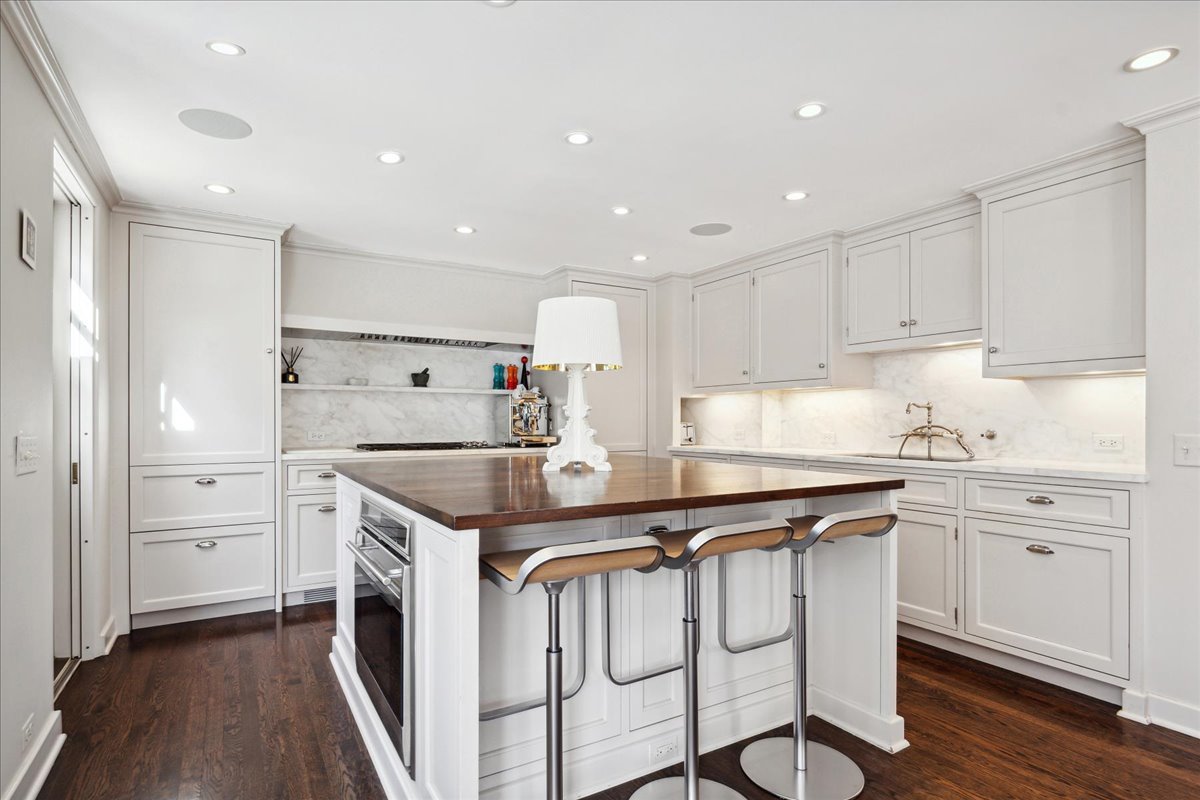 1320 Elm Tree Road Lake Forest, IL 60045 - Photo 22 of 52 a kitchen that has a lot of white cabinets and stainless steel appliances