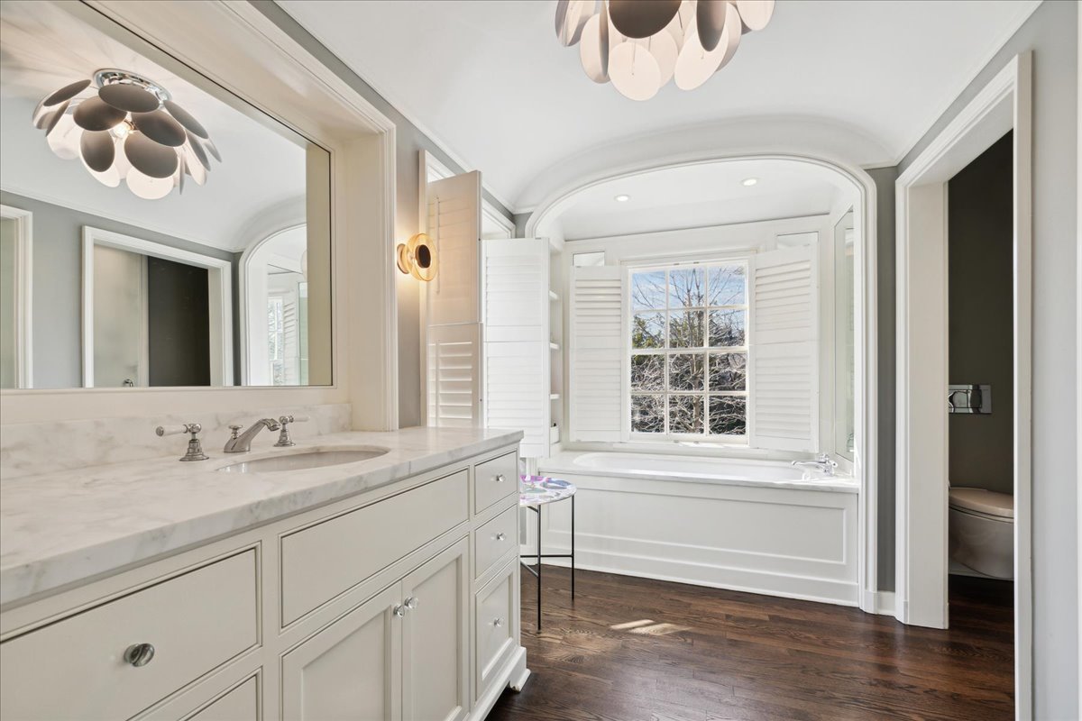 1320 Elm Tree Road Lake Forest, IL 60045 - Photo 35 of 52 a bathroom with a sink a mirror and a window