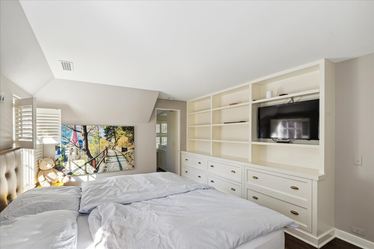1320 Elm Tree Road Lake Forest, IL 60045 - Photo 45 of 52 a bedroom with a bed and a flat tv screen on the dresser