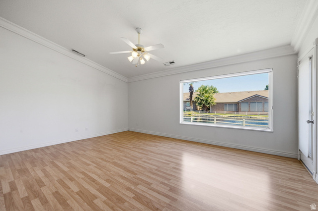805 South River Road, Unit 70 St. George, UT 84790 - Photo 15 of 38 Spacious room featuring wood-finish flooring, white walls, and crown molding
