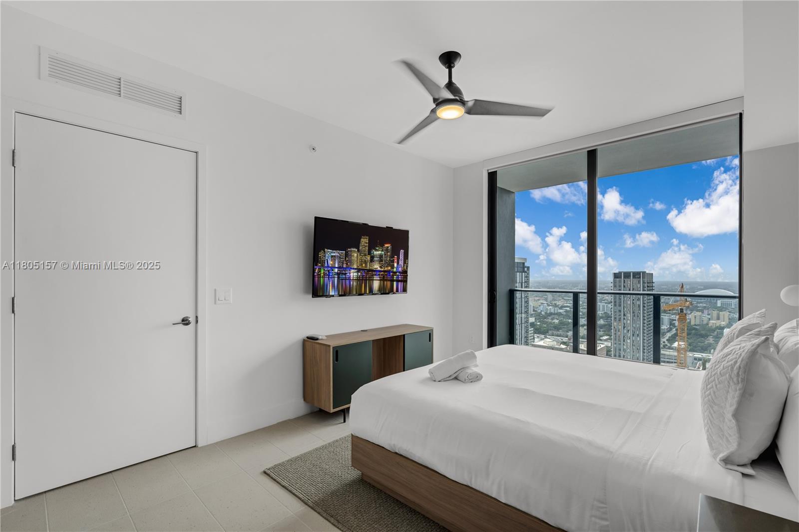 601 Northeast 1st, Unit 4204 Miami, FL 33132 - Photo 11 of 25 a bedroom with a large bed and a chandelier