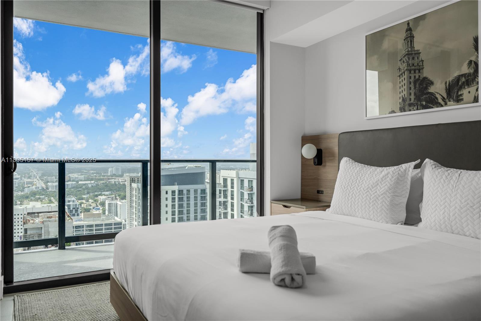 601 Northeast 1st, Unit 4204 Miami, FL 33132 - Photo 14 of 25 a bed sitting in a bedroom next to a window