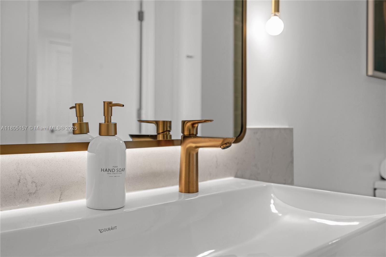 601 Northeast 1st, Unit 4204 Miami, FL 33132 - Photo 18 of 25 a close view of a faucet a sink and a mirror