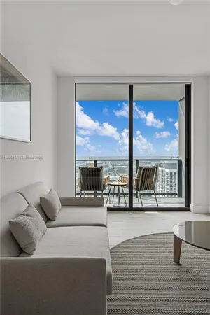 a living room with furniture and a large window