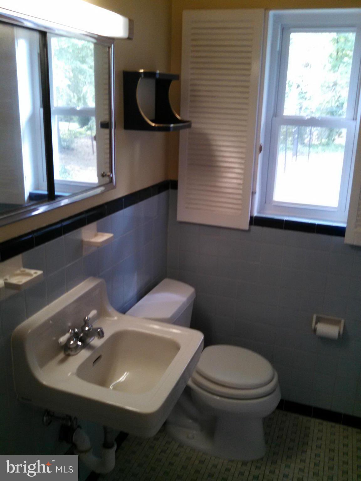 2007 Pagebrook Road Silver Spring, MD 20903 - Photo 8 of 24 a bathroom with a toilet sink and mirror