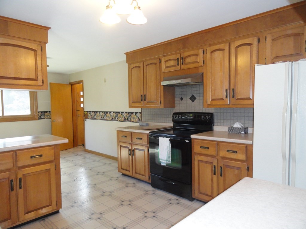 88 Charlton Road Dudley, MA 01571 - Photo 11 of 40 a kitchen with stainless steel appliances granite countertop a stove a sink and a refrigerator