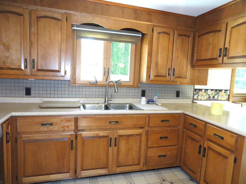 88 Charlton Road Dudley, MA 01571 - Photo 12 of 40 a kitchen with cabinets appliances a sink and a window