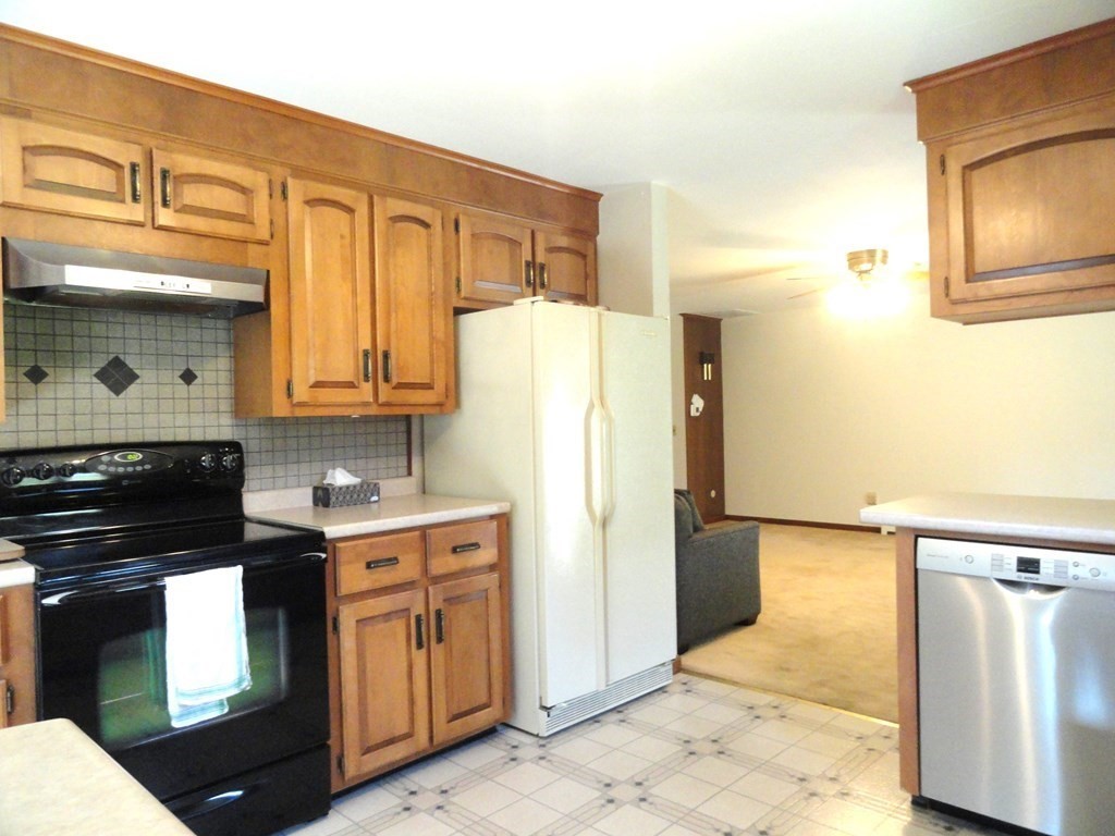 88 Charlton Road Dudley, MA 01571 - Photo 13 of 40 a kitchen with stainless steel appliances granite countertop a refrigerator a stove and a sink with large cabinets