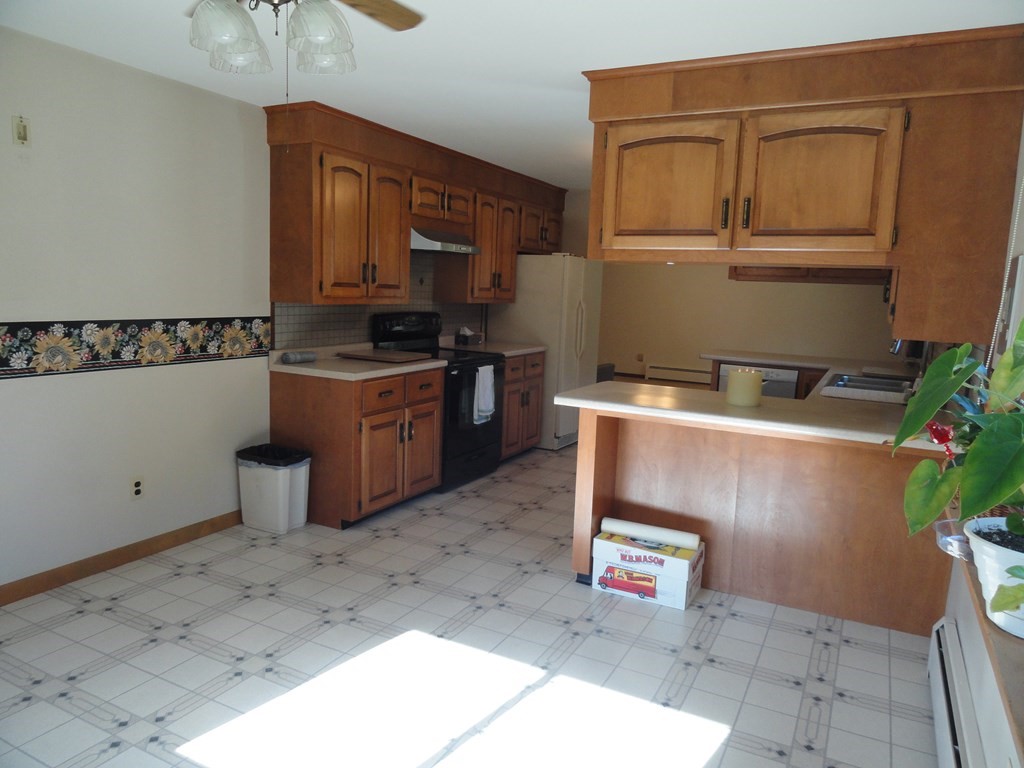 88 Charlton Road Dudley, MA 01571 - Photo 17 of 40 a kitchen with stainless steel appliances granite countertop a stove a sink and a microwave