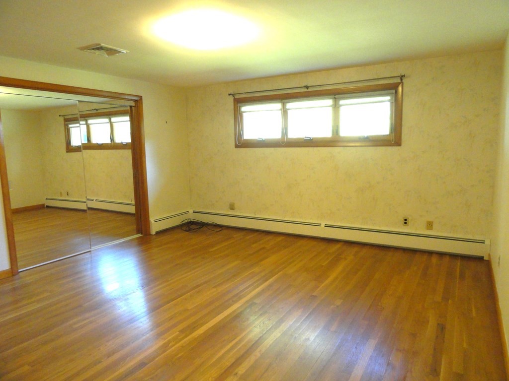 88 Charlton Road Dudley, MA 01571 - Photo 18 of 40 a view of a room with wooden floor and fan