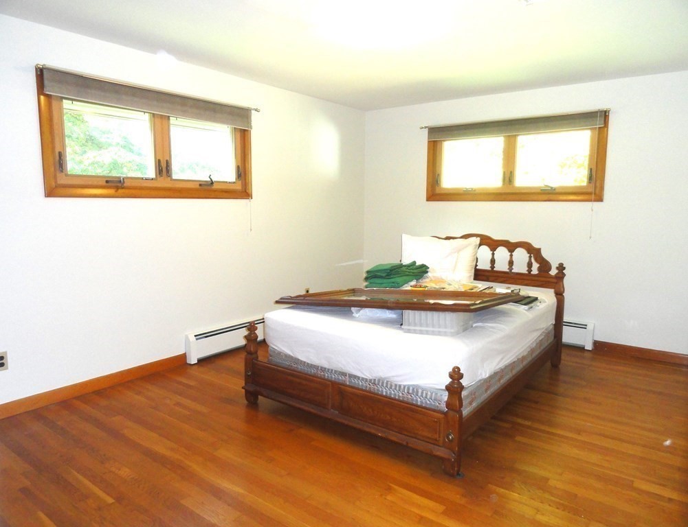 88 Charlton Road Dudley, MA 01571 - Photo 21 of 40 a bed sitting in a bedroom next to a window
