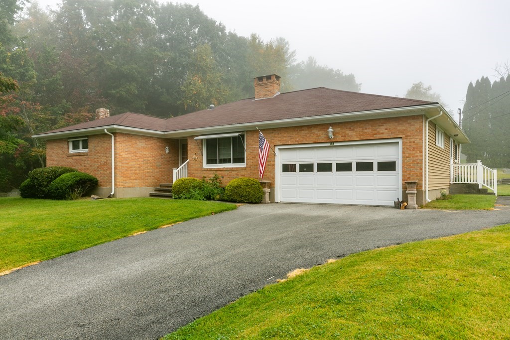 88 Charlton Road Dudley, MA 01571 - Photo 40 of 40 a front view of a house with a yard and garage
