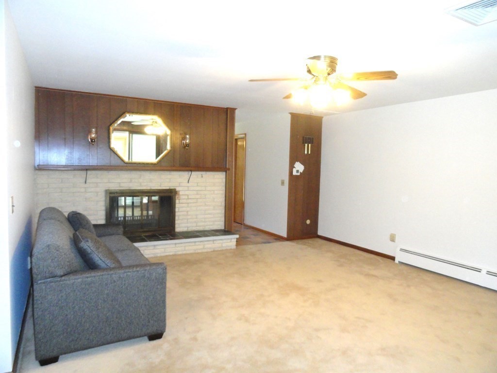 88 Charlton Road Dudley, MA 01571 - Photo 7 of 40 a living room with furniture and a fireplace