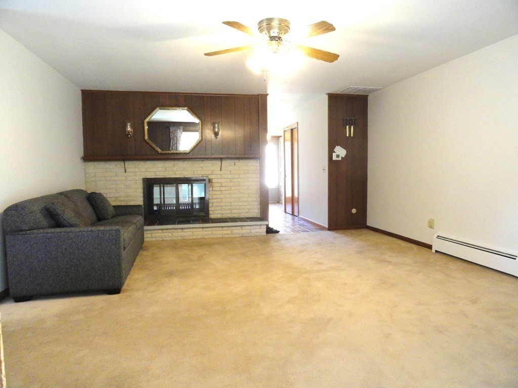88 Charlton Road Dudley, MA 01571 - Photo 8 of 40 a living room with furniture and a flat screen tv