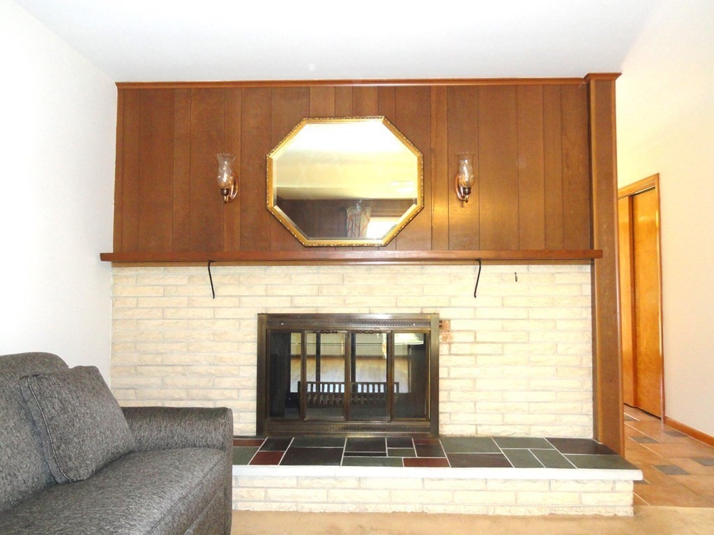 88 Charlton Road Dudley, MA 01571 - Photo 9 of 40 a living room with a couch and a coffee table