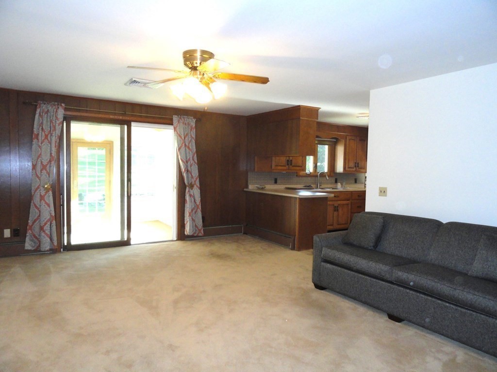 88 Charlton Road Dudley, MA 01571 - Photo 10 of 40 a living room with furniture and a chandelier