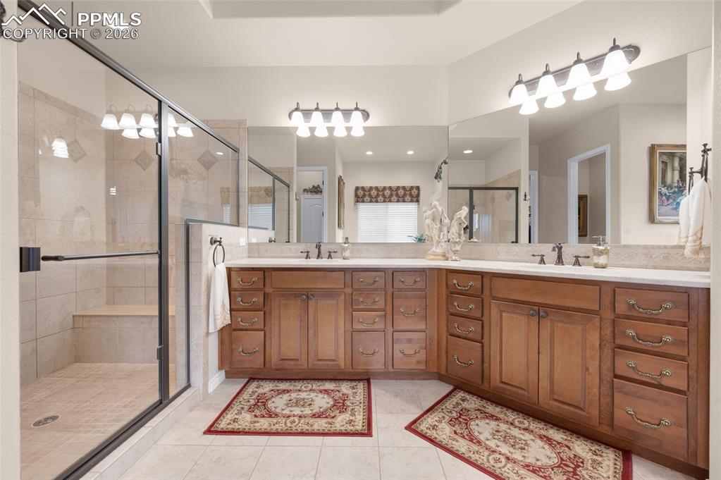 13320 Clinet Drive Colorado Springs, CO 80921 - Photo 24 of 50 a spacious bathroom with a sink a mirror and a shower