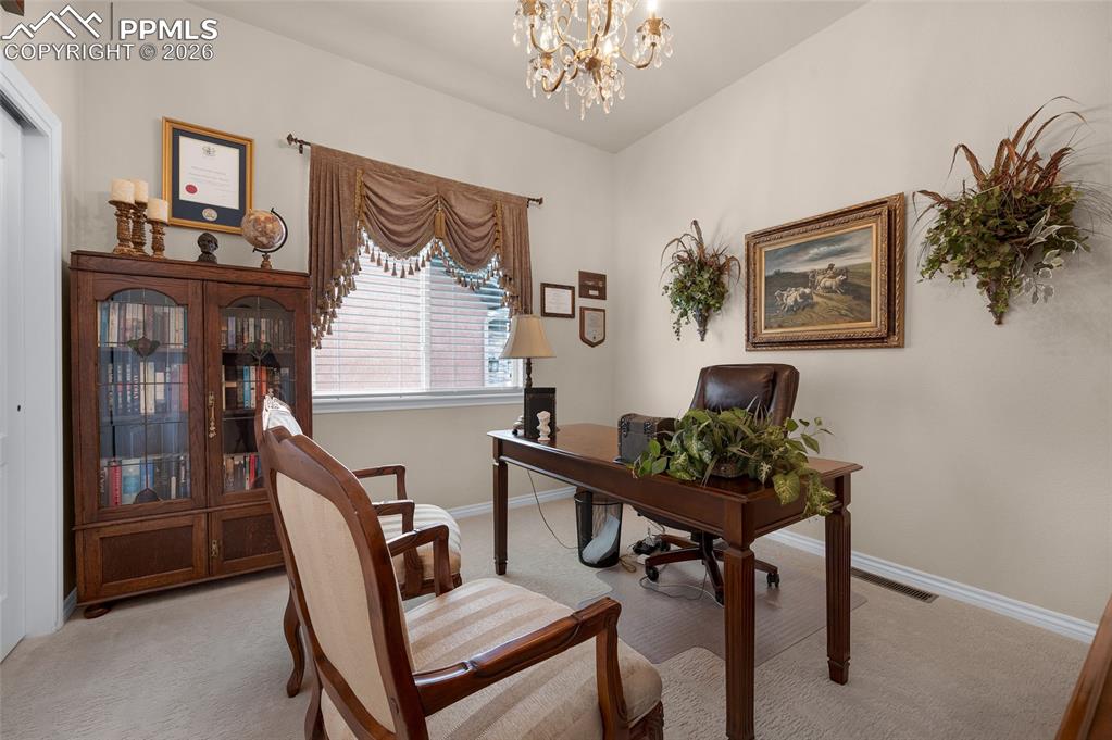 13320 Clinet Drive Colorado Springs, CO 80921 - Photo 26 of 50 a view of a workspace with furniture and a chandelier