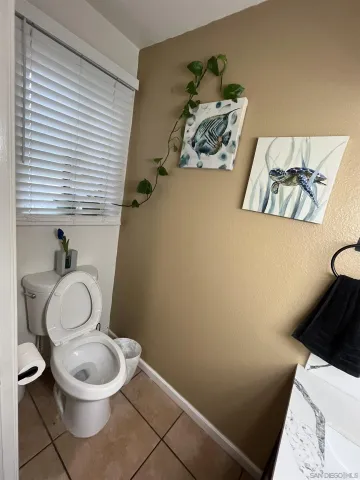 a white toilet sitting next to a small sink