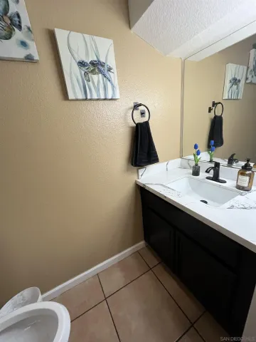 a bathroom with a sink vanity and toilet