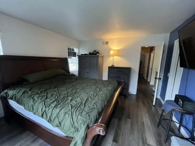 a bedroom with a bed and a television