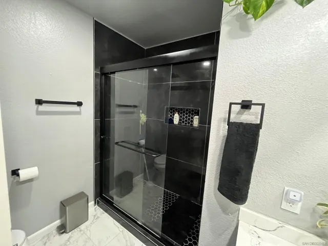 a bathroom with a glass shower door