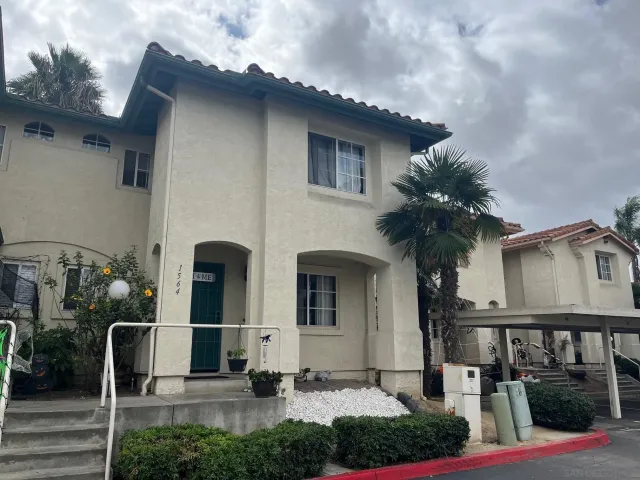 a couple of table and chairs in front of house