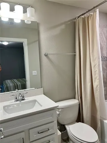 a bedroom with a bed and a chair in it