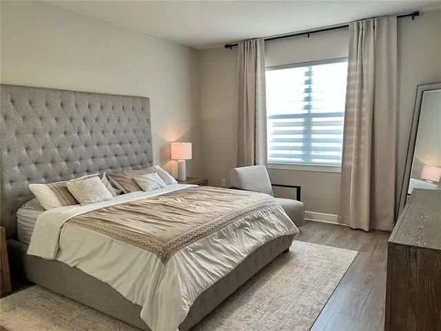 a bathroom with a granite countertop sink a mirror and shower