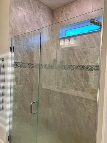 a white toilet sitting next to a small bathroom