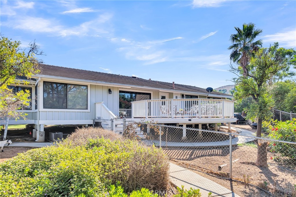 10651 Orchard View Lane Riverside, CA 92503 - Photo 32 of 35 a front view of a house with swimming pool and dining table and chairs