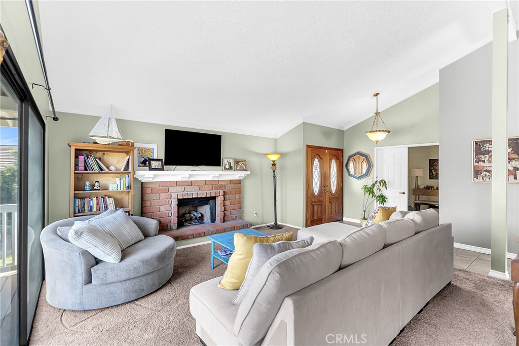 10651 Orchard View Lane Riverside, CA 92503 - Photo 4 of 35 a living room with furniture a fireplace and a flat screen tv