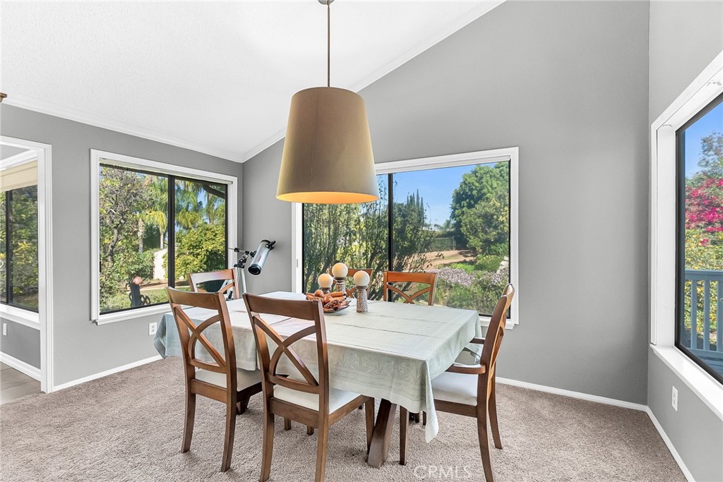 10651 Orchard View Lane Riverside, CA 92503 - Photo 5 of 35 a dining room with furniture a chandelier and wooden floor
