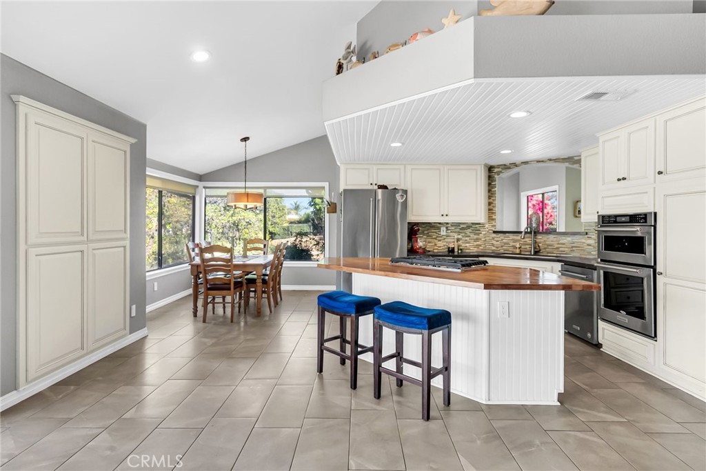 10651 Orchard View Lane Riverside, CA 92503 - Photo 9 of 35 a kitchen with stainless steel appliances granite countertop a table and chairs in it