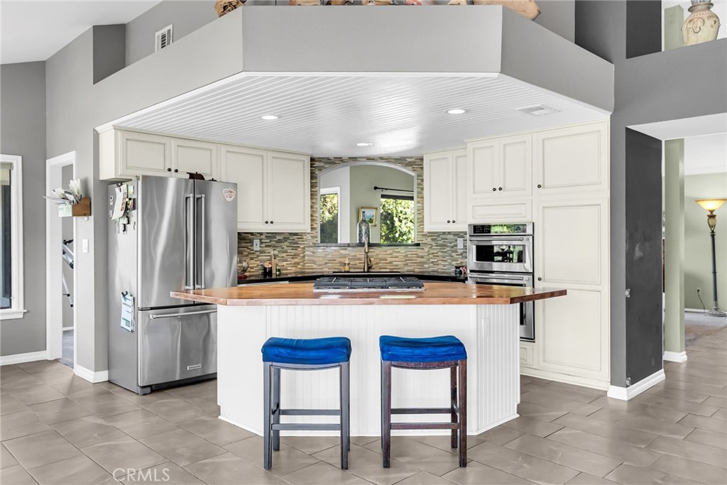 10651 Orchard View Lane Riverside, CA 92503 - Photo 10 of 35 a kitchen with stainless steel appliances granite countertop a refrigerator and a stove top oven