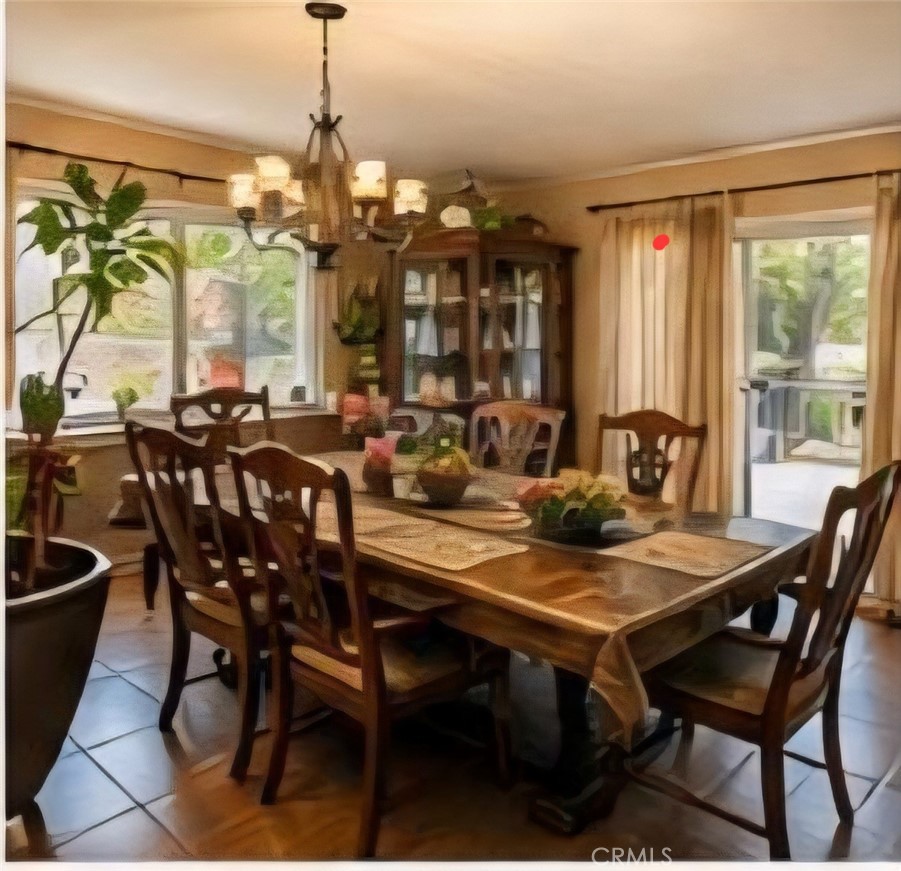 4267 Baggett Drive Riverside, CA 92505 - Photo 4 of 28 a view of a dining room and livingroom with furniture wooden floor a chandelier